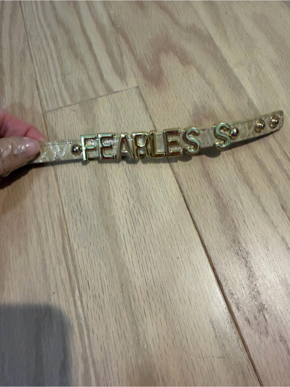 BCBGeneration Cream Patent Leather Bracelet with Gold 'FEARLESS' Letters